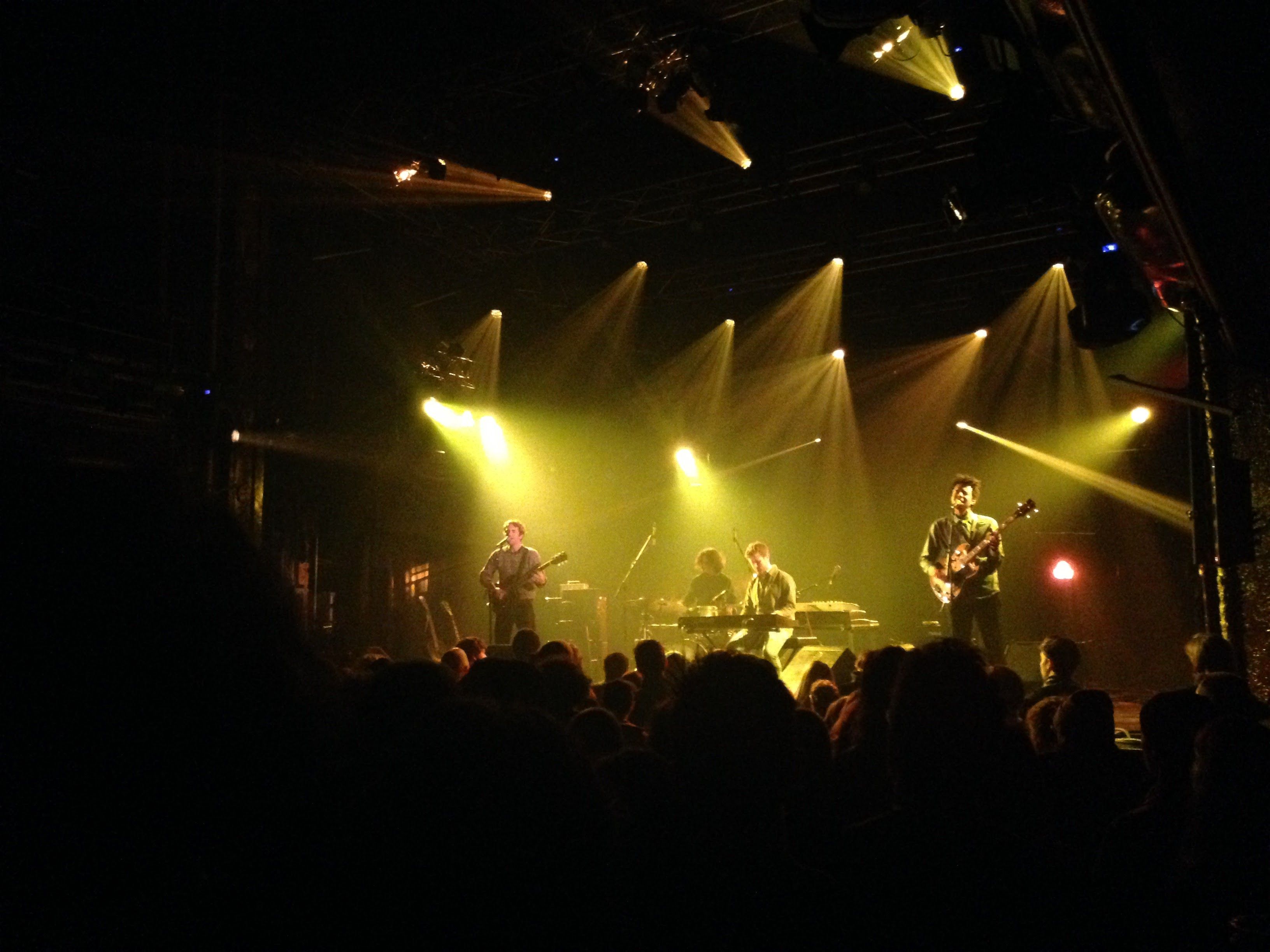Chris and his band in a venu photographed from the back