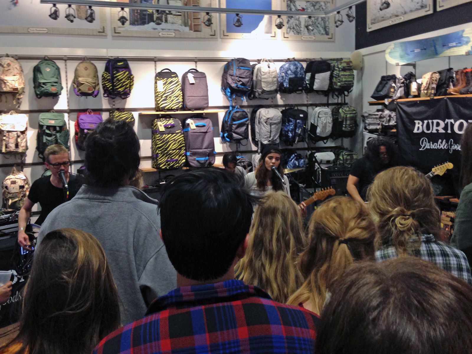Best Coast playing a small show surrounded by backpacks