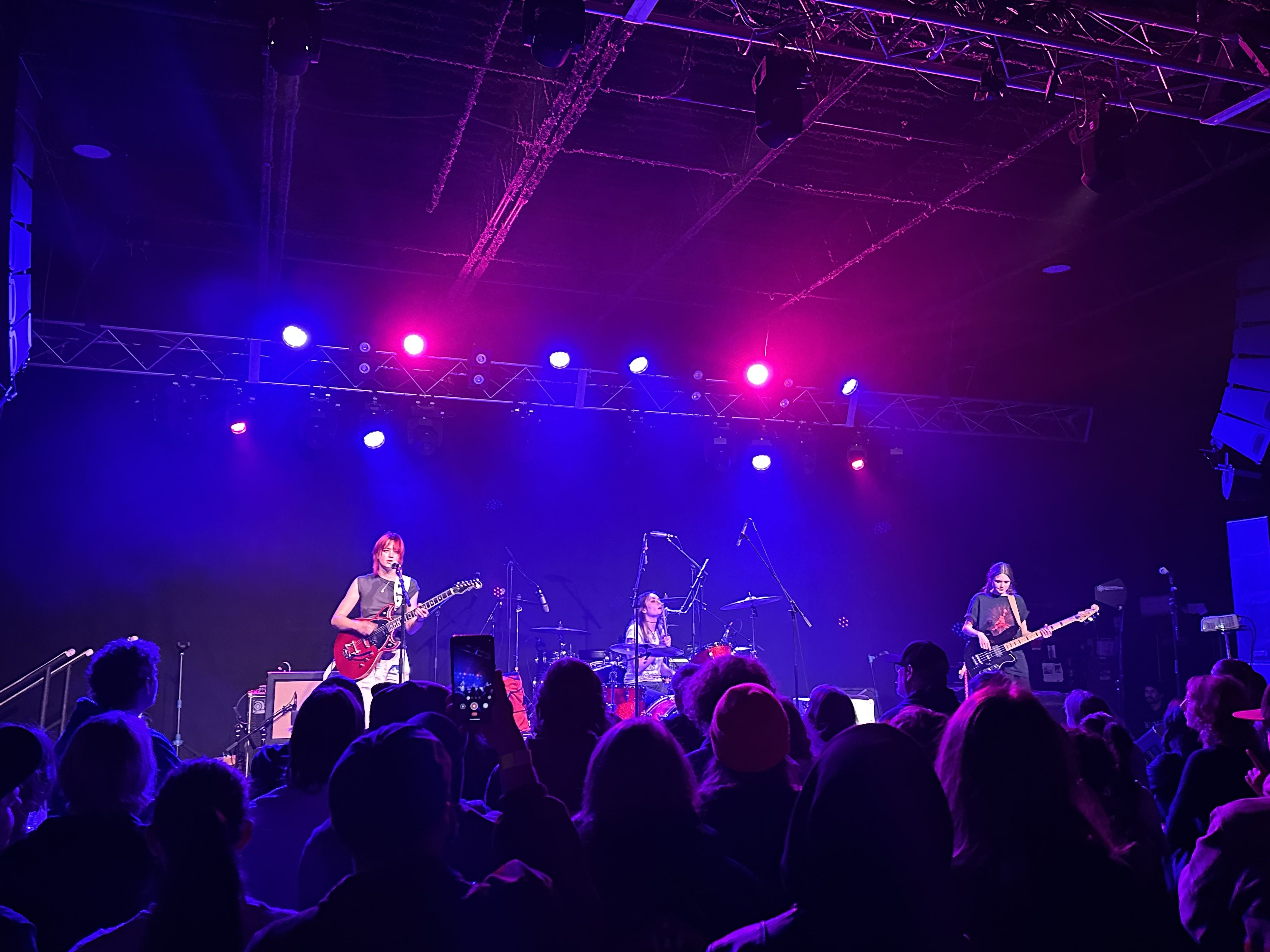 Opener Hello Mary on stage, the drummer and lead guitarist are harmonizing