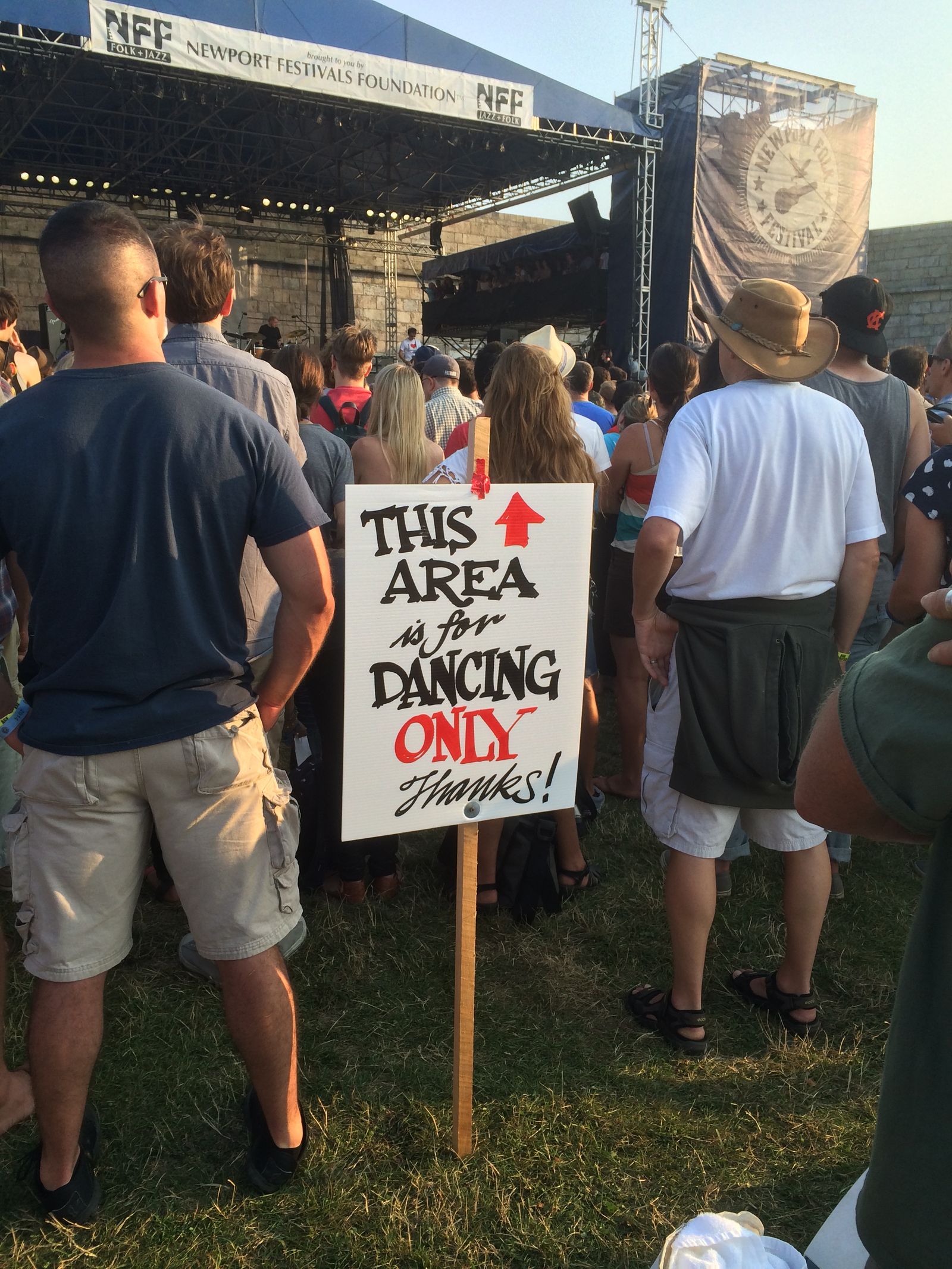 Hand-painted sign reading 'THIS AREA is for DANCING ONLY' at Newport Folk Festival