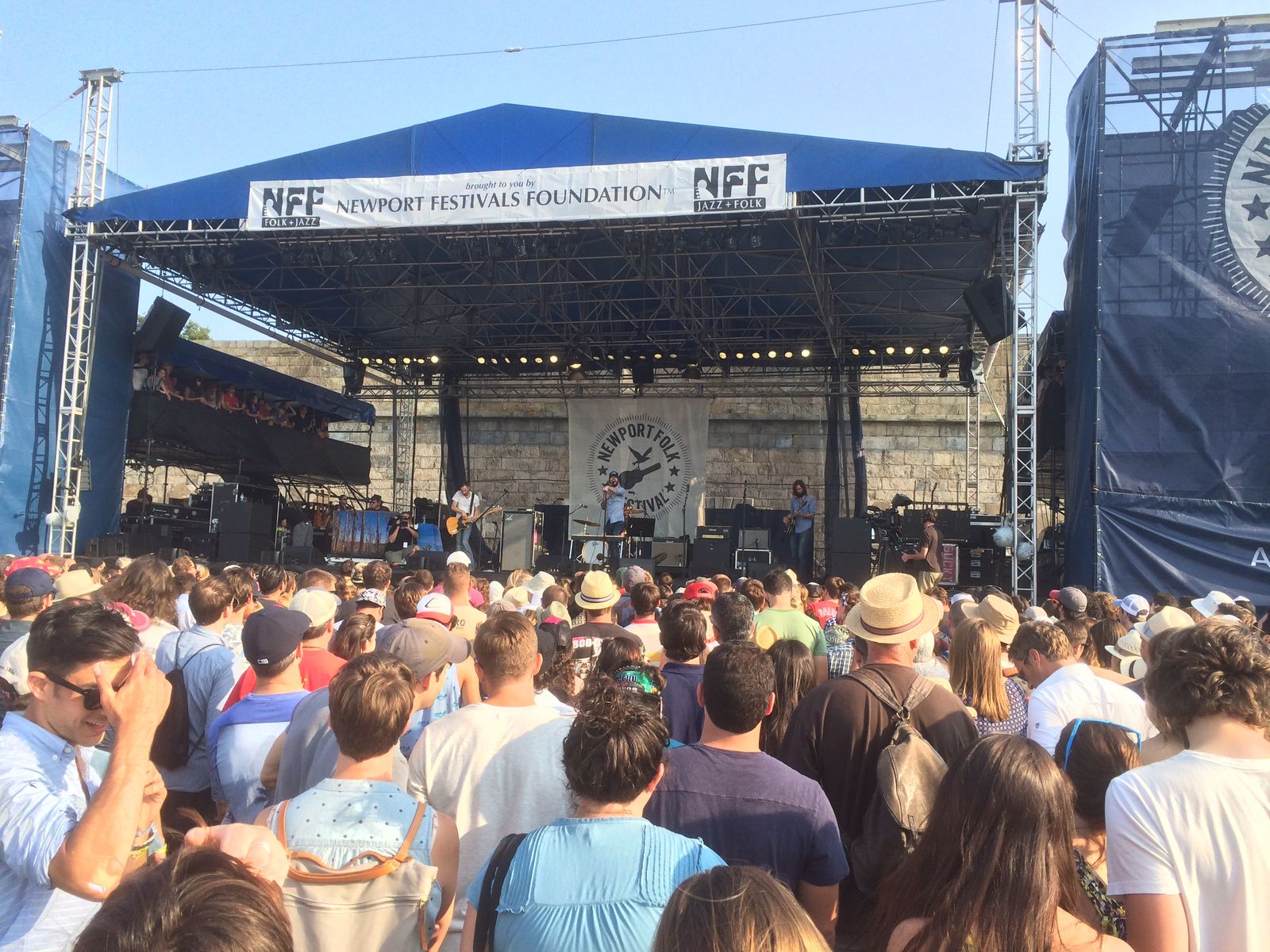 Band of Horses performing on the Fort Stage at Newport Folk Festival, stone wall backdrop