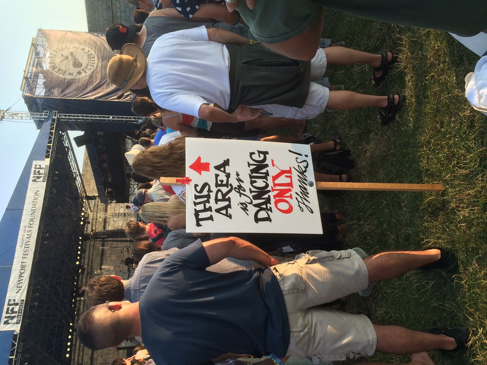 Hand-painted sign reading 'THIS AREA is for DANCING ONLY' at Newport Folk Festival