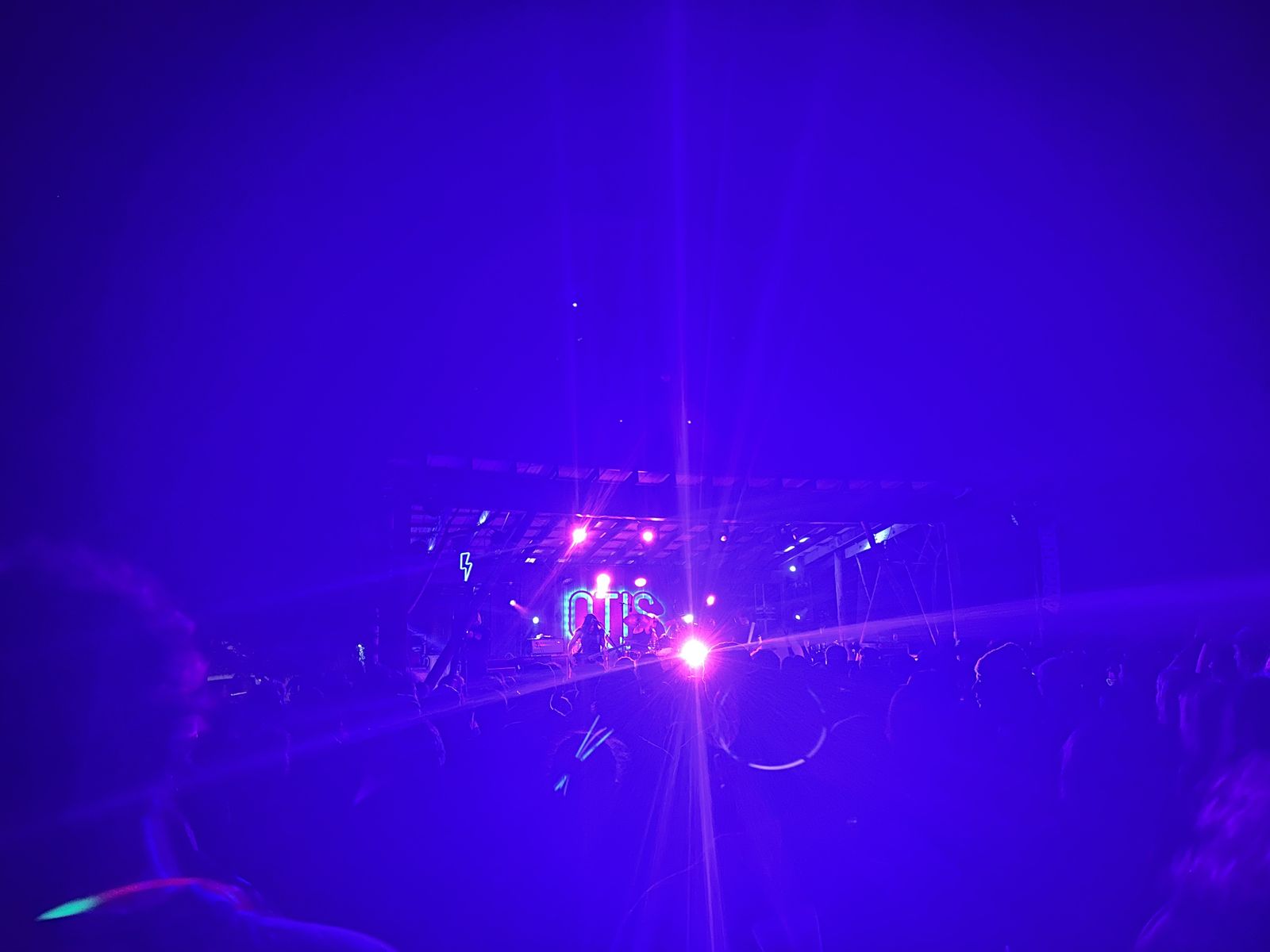 Night photo of the band with lights blinding the camera