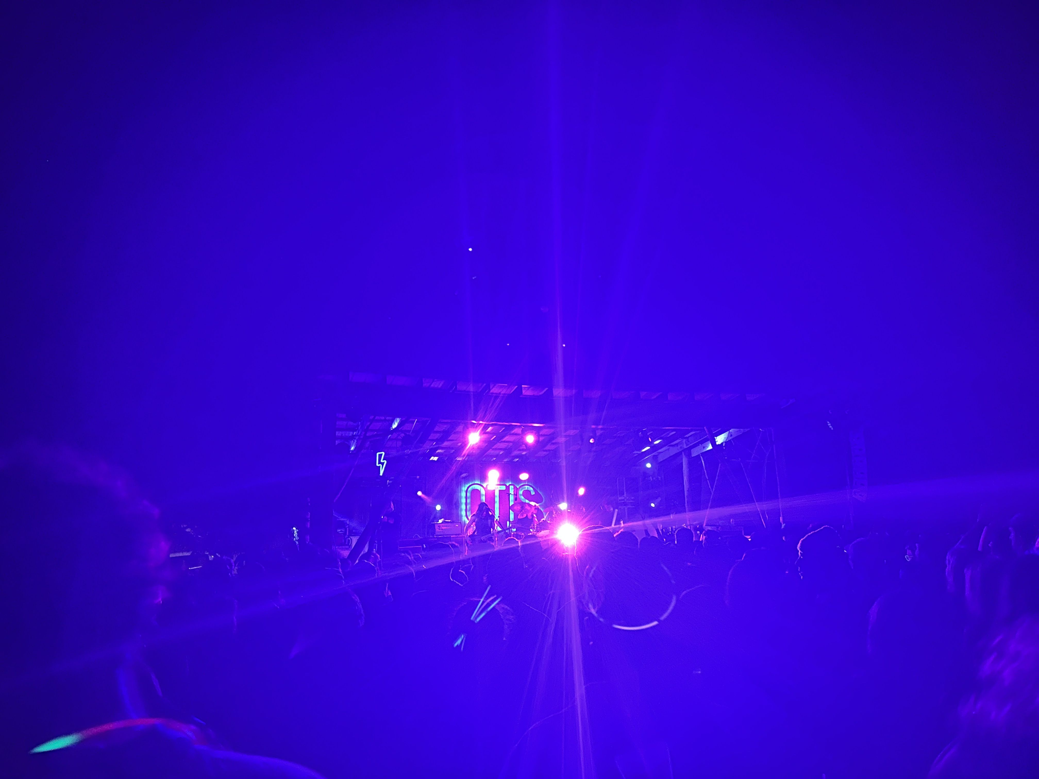 Night photo of the band with lights blinding the camera