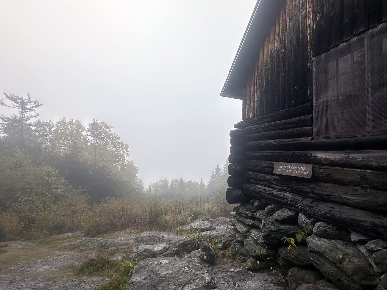 Lodge off to the right and nothing but fog where a view should be, on the left.