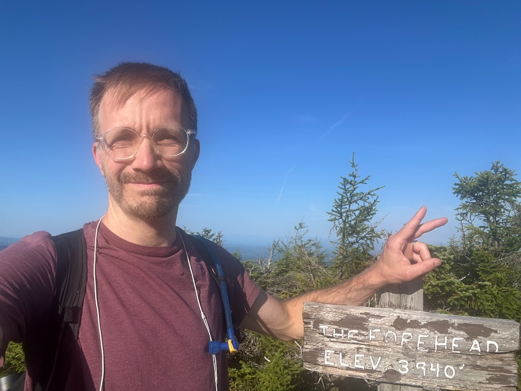 Selfie at The Forehead summit sign, elevation 3940, clear blue sky